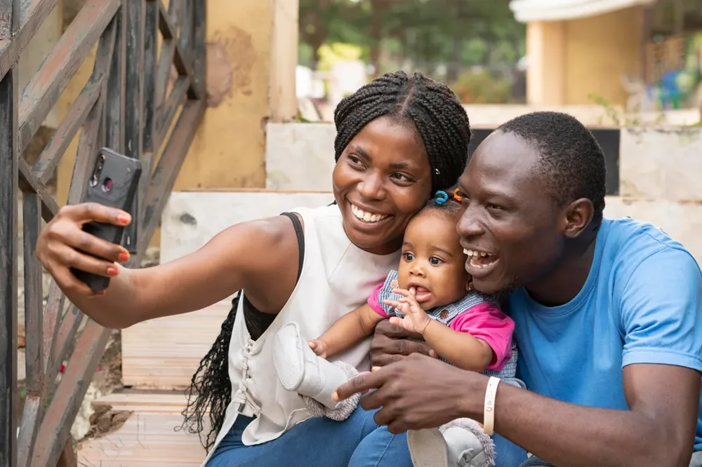 Parents with their baby taking a phone selfie